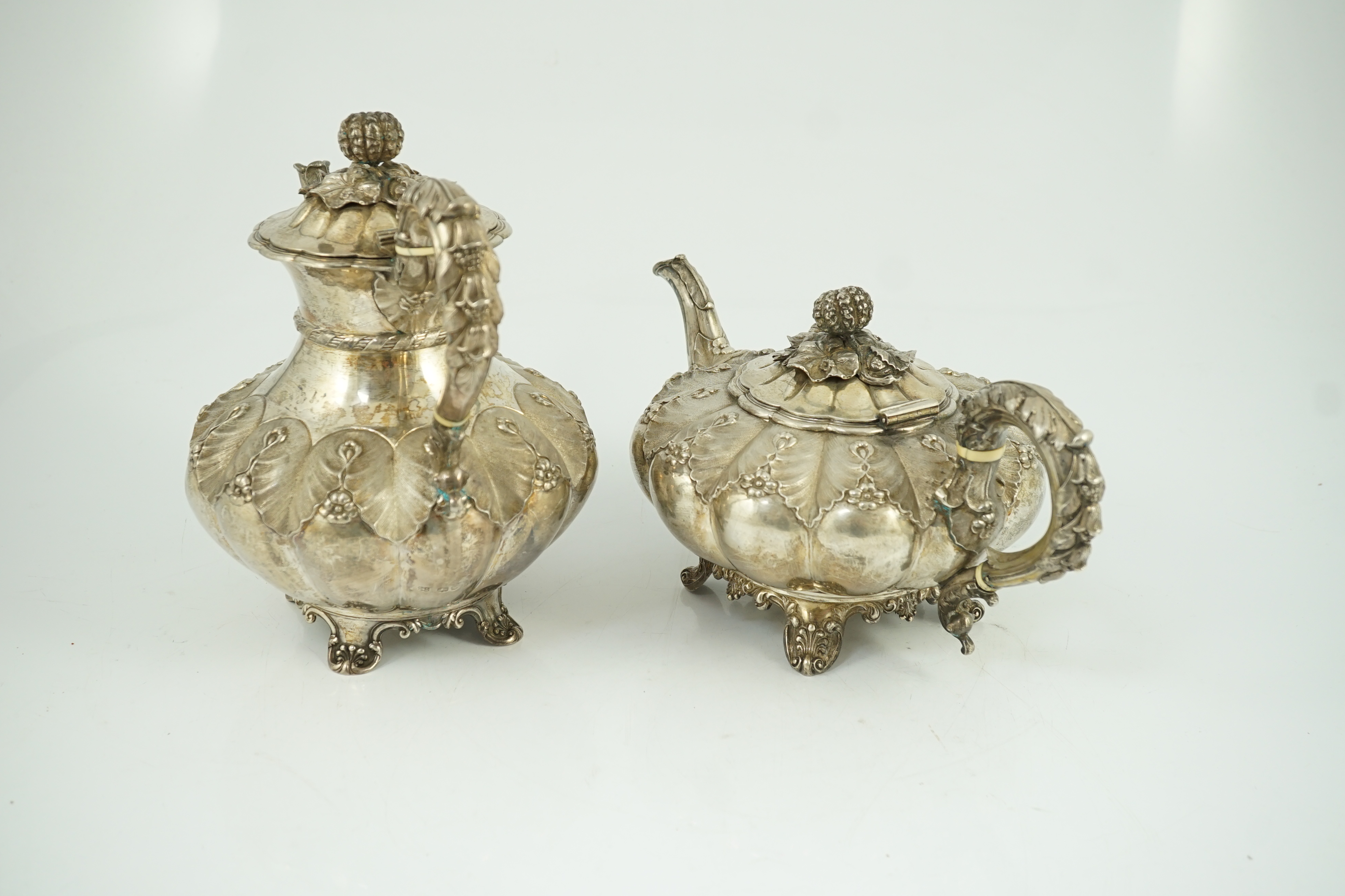 A George IV silver melon shaped coffee pot and matching tea pot by The Barnards